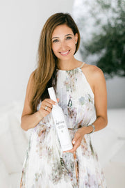 Woman holding Kosterina - Original Extra Virgin Olive Oil (375ml) bottle, showcasing premium olive oil from early harvest Koroneiki olives, emphasizing its rich polyphenol content.