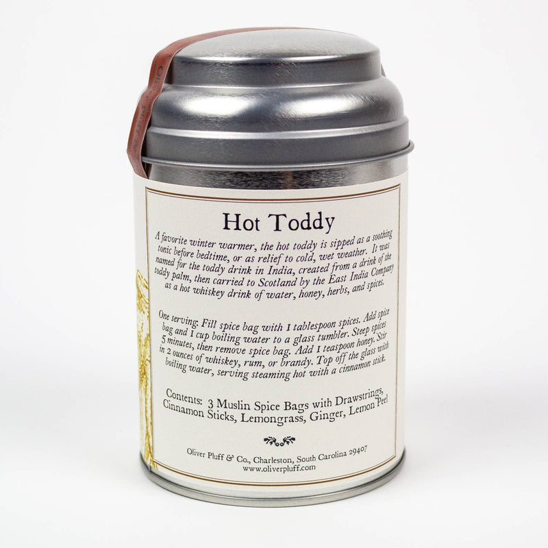Oliver Pluff & Company - Lemon Ginger Hot Toddy Kit canister featuring winter spices for a warm beverage, including cinnamon, lemongrass, ginger, and lemon peel, with brewing instructions.