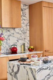 W&P Glass Seal Tight To-Go & Storage Bowl, 16 oz, sits on a marble kitchen counter, ideal for leak-proof storage and meal prep, with a silicone sleeve and airtight lid.