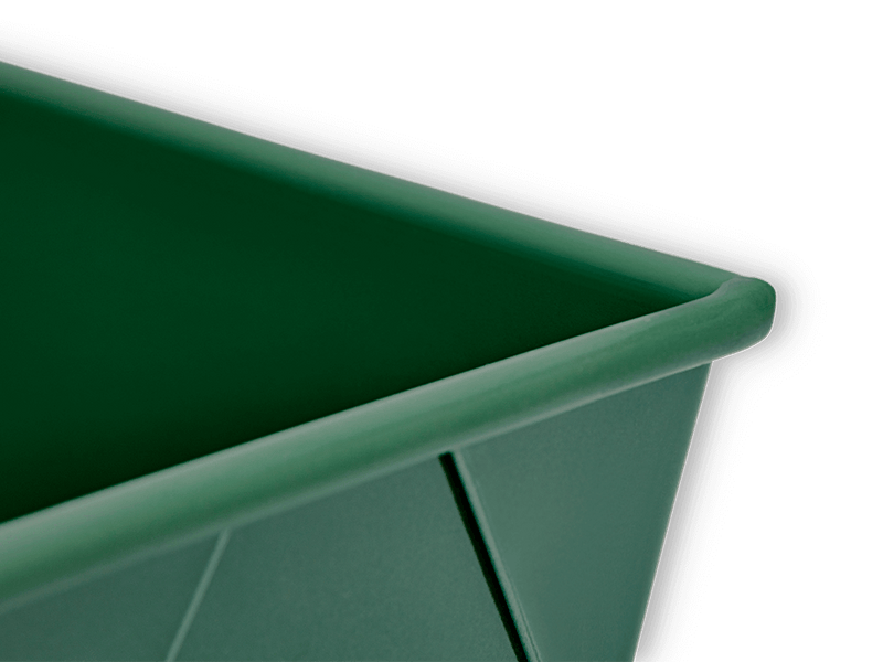 Great Jones | Breadwinner - Raspberry loaf pan with a unique wavy, corrugated bottom, designed for easy release and scratch resistance, featured against a black background.