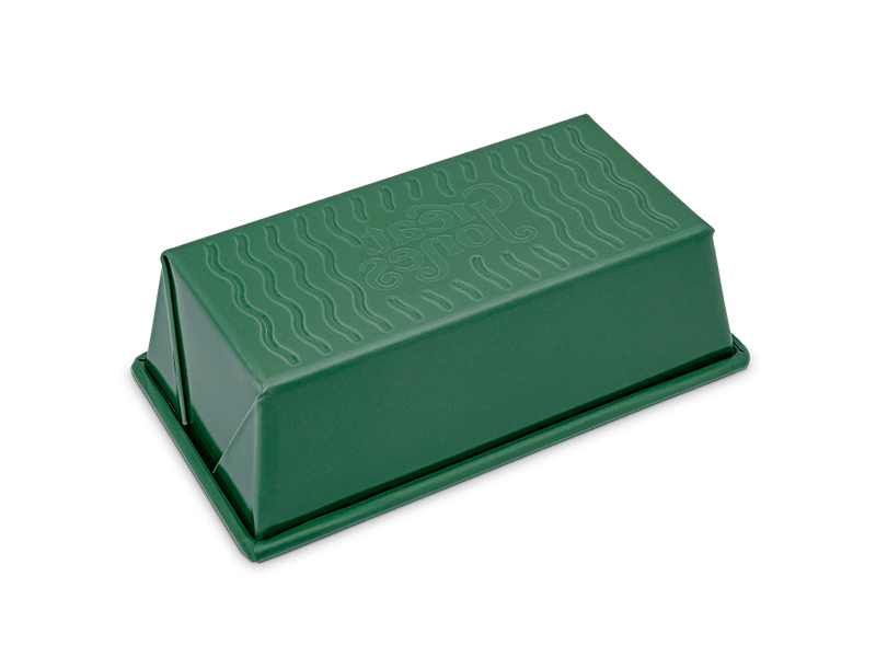 Great Jones | Breadwinner - Raspberry loaf pan with text, featuring a wavy, nonstick, ceramic-coated surface for easy release of baked goods.