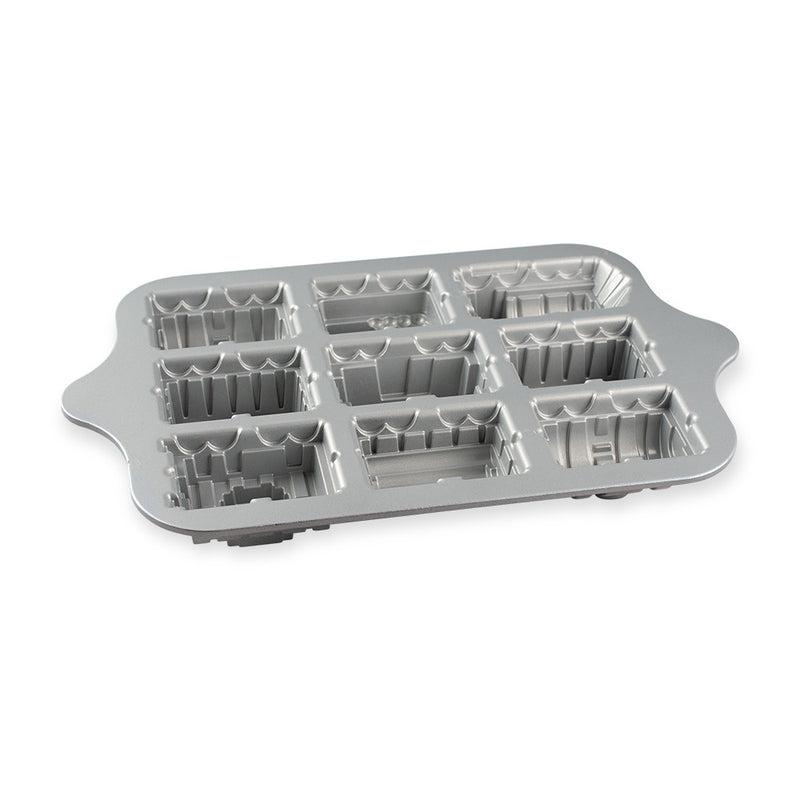 Nordic Ware | Train Cake Pan featuring nine train-shaped molds on a silver tray with holes, perfect for creative baking with children.