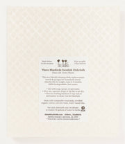 Three Bluebirds Swedish Dishcloth - Peaches, featuring a white label. Ideal for eco-friendly cleaning, replacing paper towels, and is biodegradable.