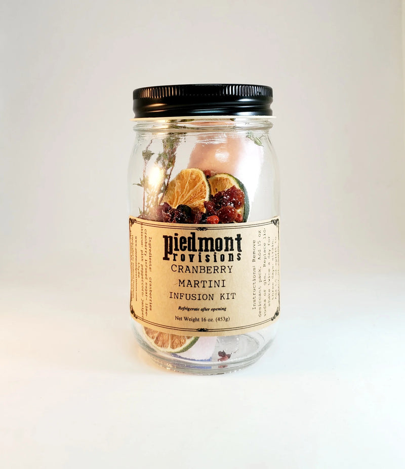 Piedmont Provisions Cranberry Martini Cocktail Infusion Kit in a glass jar with dried citrus, cranberries, and botanicals, ideal for homemade cranberry martinis.