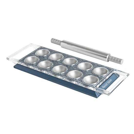 Marcato Ravioli Tablet Pasta Maker with baking tins and rolling pin, designed for creating evenly sized, authentic Italian ravioli at home.