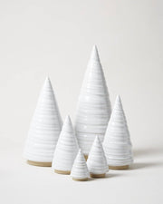 Farmhouse Pottery - Spruce Woodland Trees: Petite, minimalist ceramic cone sculptures with ribbed texture and unglazed base, elegantly arranged in ascending height for versatile decor.
