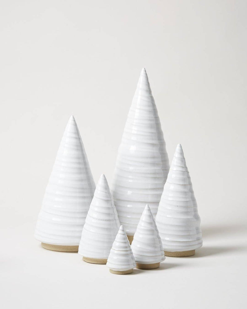 Farmhouse Pottery - Spruce Woodland Trees: Petite, minimalist ceramic cone sculptures with ribbed texture and unglazed base, elegantly arranged in ascending height for versatile decor.