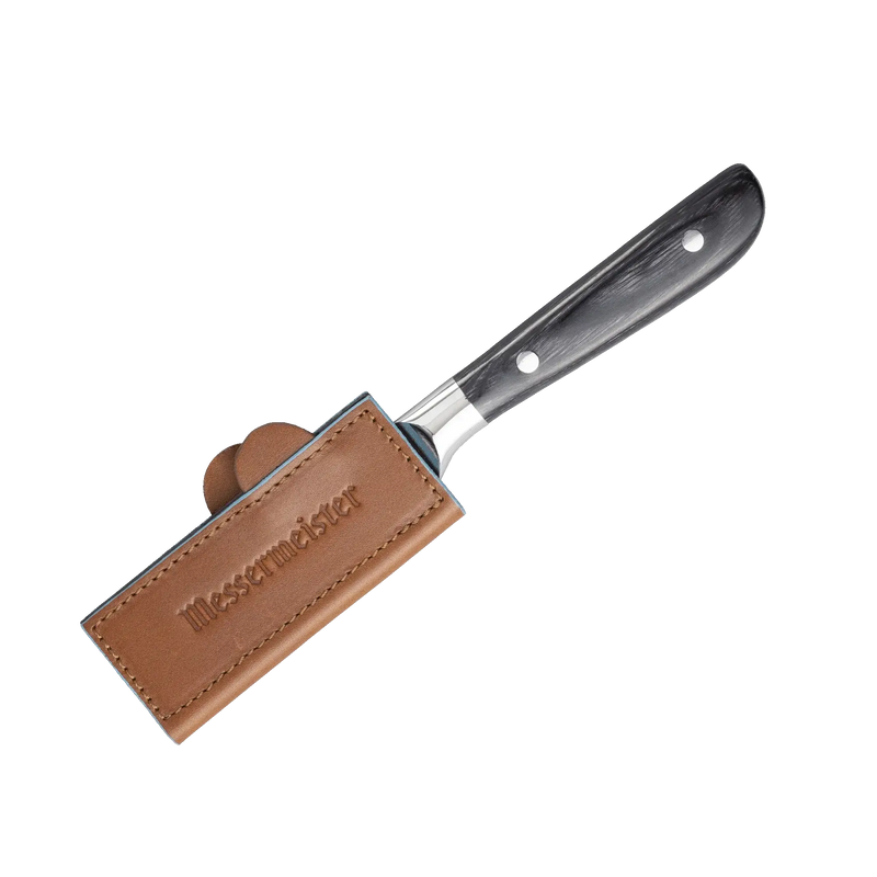 Messermeister Leather Magnetic Edge-Guard - 4, sheathed on a small kitchen knife with a dark handle, showcases a protective tan leather slip stamped Messermäster.