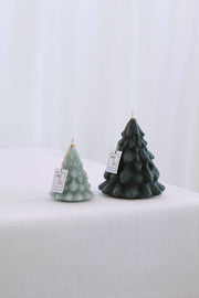 Mo&Co Home Exclusive: Sculpted Beeswax Trees, featuring two evergreen-inspired candles on a white surface, showcasing artisanal craftsmanship in two sizes for holiday elegance.