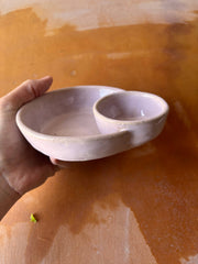 Hand holding a ROB Ceramics - Olive Serving Bowl Handmade: White, featuring two connected wells, ideal for olives and pits, perfect for entertaining or gifting.