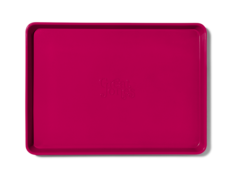Great Jones | Holy Sheet - Pepper, a nonstick pink rectangular tray, ideal for easy clean-up and stylish table presentation, perfect for kitchen enthusiasts.