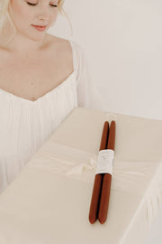 Mo&Co Home - Burgundy | Dipped Beeswax Taper Candles | All Natural: 14 Inches, elegantly presented with a fabric-wrapped box, embodying a minimalist, eco-conscious aesthetic.