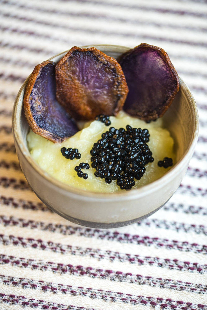 TartufLanghe - Truffle Perlage – Caviar-Style Pearls atop creamy purée, garnished with crisp purple chips, showcasing elegant culinary innovation for gourmet plating.