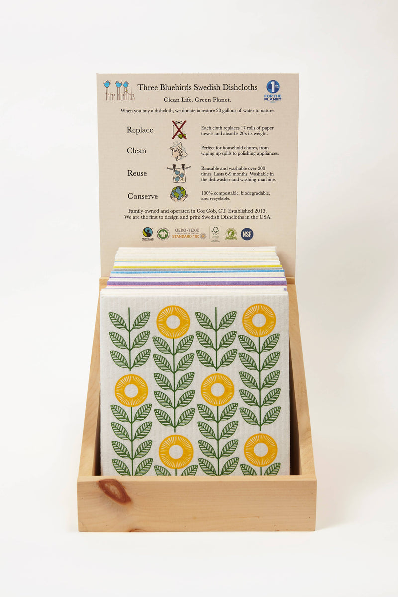 Three Bluebirds Swedish Dishcloths - Pink Wildflowers, featuring a biodegradable cloth with floral designs, presented in a wooden display box.