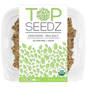 Top Seedz Sea Salt Crackers in a plastic container, featuring a white and green label, highlighting the flagship 5oz product with a satisfying crunch.