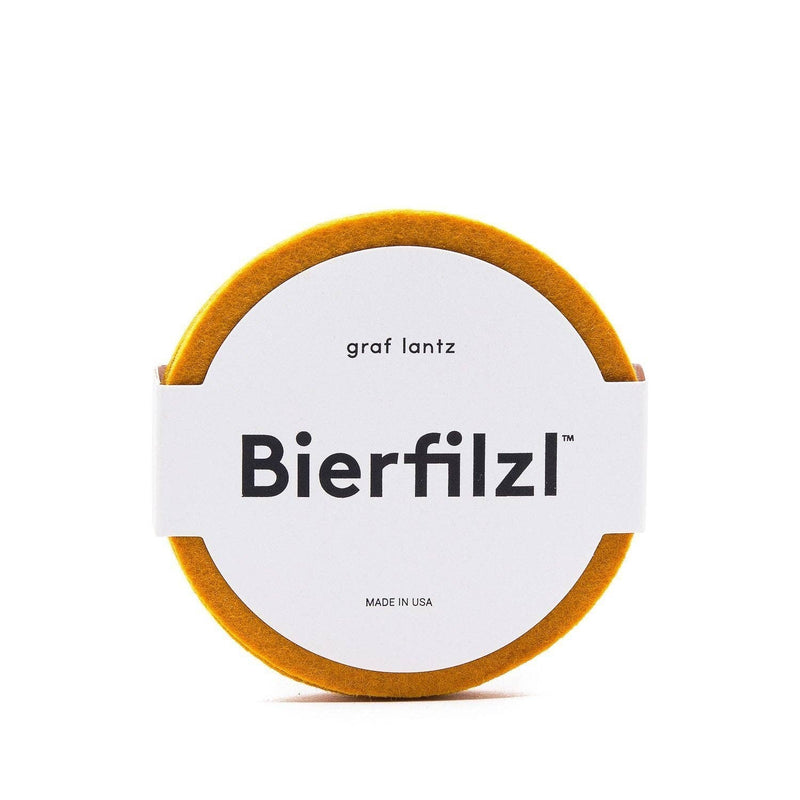 Graf Lantz - Bierfilzl Merino Wool Felt Round Coaster Solid 4 Pack: Turmeric, featuring round orange and white design, crafted from 5mm thick German merino wool.