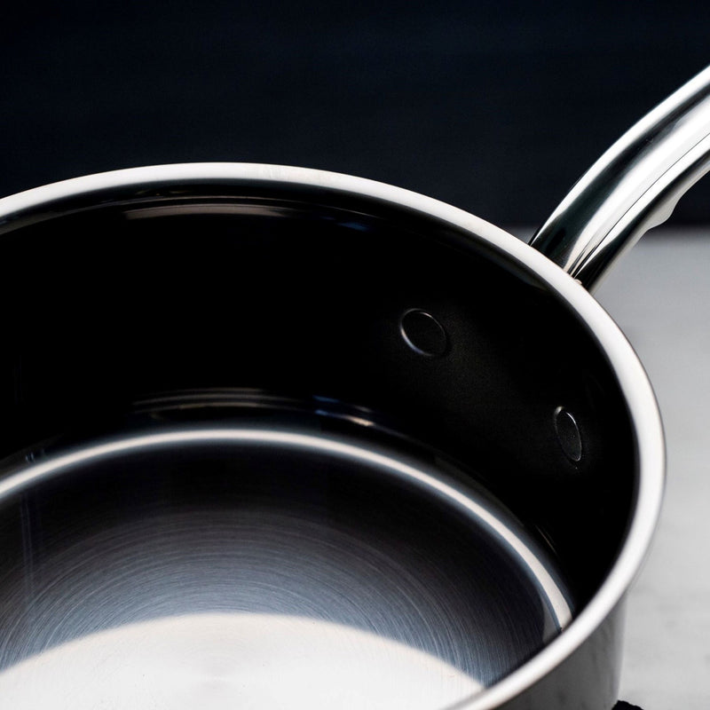 Hestan NanoBond | Cookware, 3qt Saucepan + Lid: Overhead view highlighting its polished stainless-steel interior and ergonomic handle, showcasing durable molecular titanium construction for efficient cooking.