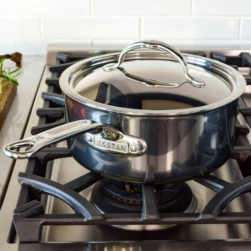 Hestan Provisions | Stainless Steel Lids Dome, 14 on gas stove, showcasing durable tri-ply construction and ergonomic handle for optimal cooking and heat retention.