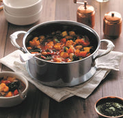 Hestan | NanoBond Cookware, 3qt Soup Pot filled with vegetable stew, featuring ergonomic handles and a ladle, showcasing durable, innovative titanium-bonded stainless steel technology.