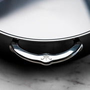Close-up of Hestan | NanoBond Cookware, 3.5qt Sauteuse lid, featuring a D-shaped handle with a stamped emblem, showcasing premium craftsmanship for Athens Cooks customers.