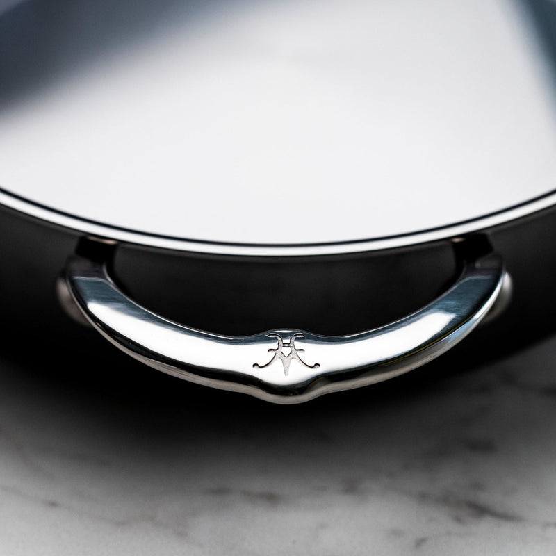 Close-up of Hestan | NanoBond Cookware, 3.5qt Sauteuse lid, featuring a D-shaped handle with a stamped emblem, showcasing premium craftsmanship for Athens Cooks customers.