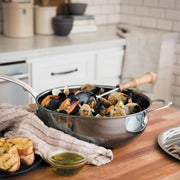 Hestan | NanoBond Cookware, 5qt Essential Pan + Lid, filled with seafood stew, showcasing its ergonomic handle and durable stainless-steel construction for culinary perfection.