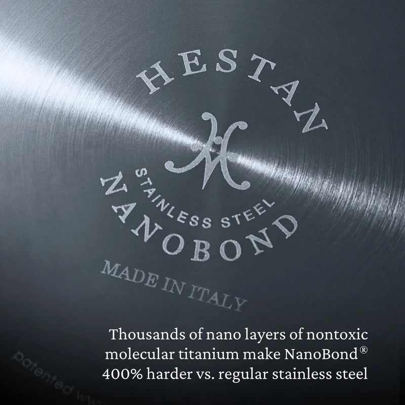 Close-up of Hestan | Titanium Essential 5-Piece Cookware Set's Nanobond® stainless-steel base with embossed branding, highlighting its 400% harder titanium nano-layer construction. Made in Italy.