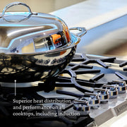 Hestan Nanobond 14 Wok, a sleek silver pot with a lid, shown on a stove, ideal for diverse cooking needs at Athens Cooks.