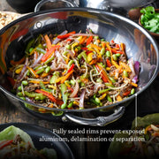 Hestan | Nanobond 14 Wok featuring a vibrant vegetable stir-fry, showcasing its cooking efficiency and versatility, ideal for culinary enthusiasts.