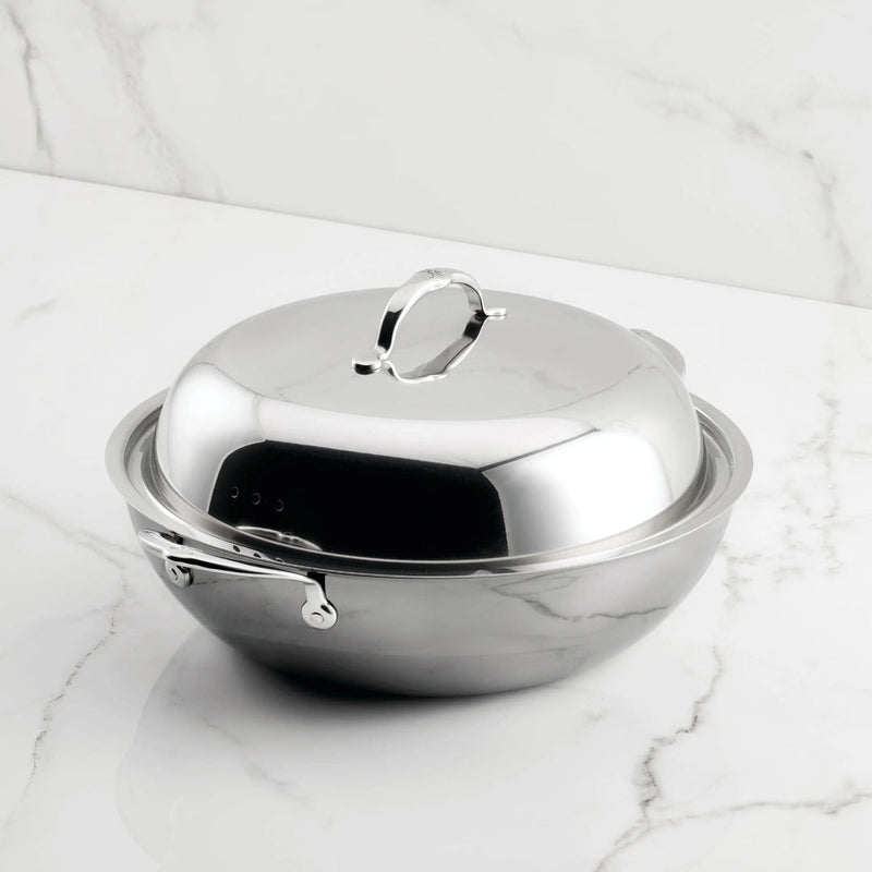 Hestan NanoBond 14 Wok with domed lid on marble, showcasing ergonomic handle and titanium-strengthened stainless steel for high-heat cooking, perfect for Athens Cooks' curated kitchen collection.