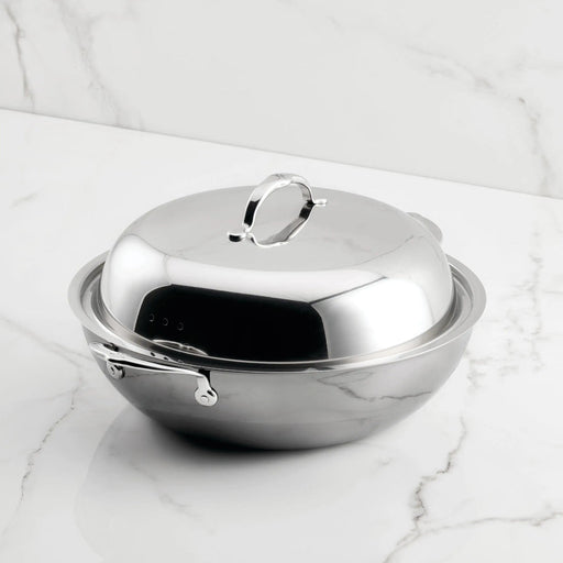 Hestan NanoBond 14 Wok with domed lid on marble, showcasing ergonomic handle and titanium-strengthened stainless steel for high-heat cooking, perfect for Athens Cooks' curated kitchen collection.