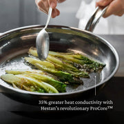 Hestan | Titanium Essential 5-Piece Cookware Set showcasing its heat conductivity with grilled romaine lettuce basted in hot oil, emphasizing innovative ProCore™ technology.