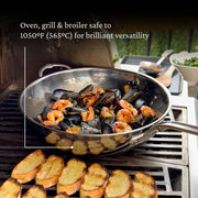 Hestan NanoBond 14 Titanium Chef's Pan on grill with mussels, shrimp, and bruschetta slices, showcasing versatility and durability for high-temperature cooking at Athens Cooks.