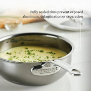 Hestan | Cookware, 2qt Saucier Pan + Lid filled with soup, showcasing sealed rims and titanium resilience for superior cooking performance.