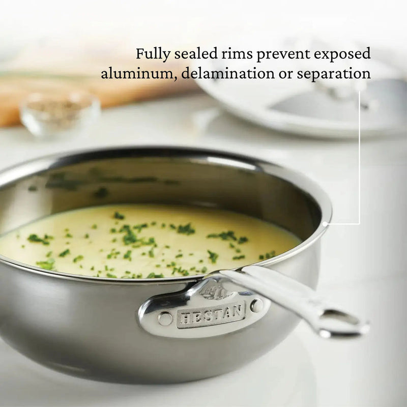Hestan | Cookware, 2qt Saucier Pan + Lid filled with soup, showcasing sealed rims and titanium resilience for superior cooking performance.