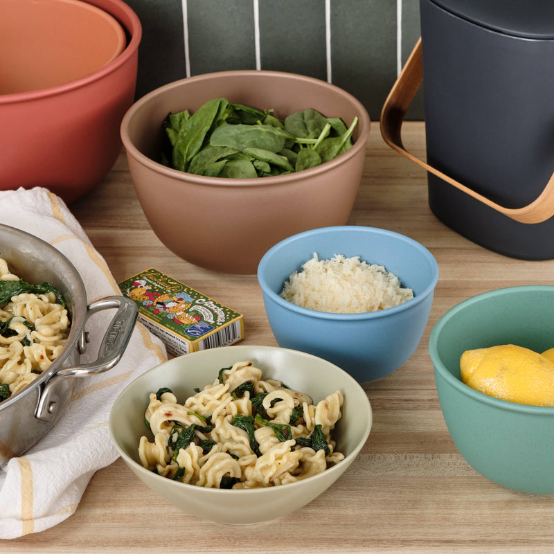 Bamboozle - 5-Piece Astrik Mixing Bowl Set: Fresh Guacamole displayed on a table with various foods, highlighting their versatile use in culinary tasks.