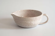 RachaelPots | Salad Dressing Bowl - Nude: Multi-functional hand-thrown bowl with garlic scraper, handle, and pour spout, ideal for dressings, marinades, or personal guacamole servings.