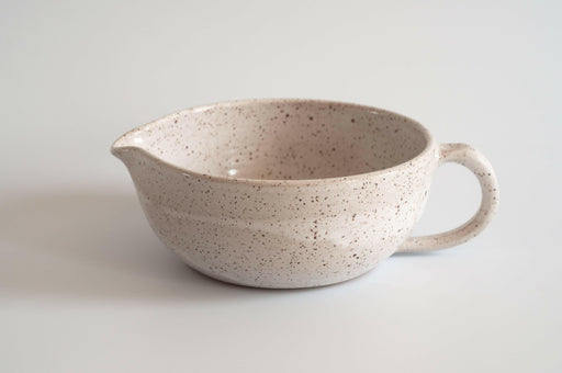 RachaelPots | Salad Dressing Bowl - Nude: Multi-functional hand-thrown bowl with garlic scraper, handle, and pour spout, ideal for dressings, marinades, or personal guacamole servings.