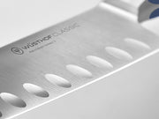 Wüsthof | Classic 7 Hollow Edge Santoku Wild Blueberry knife, close-up view of blade, highlighting its precision craftsmanship, ideal for culinary enthusiasts seeking premium kitchen tools.