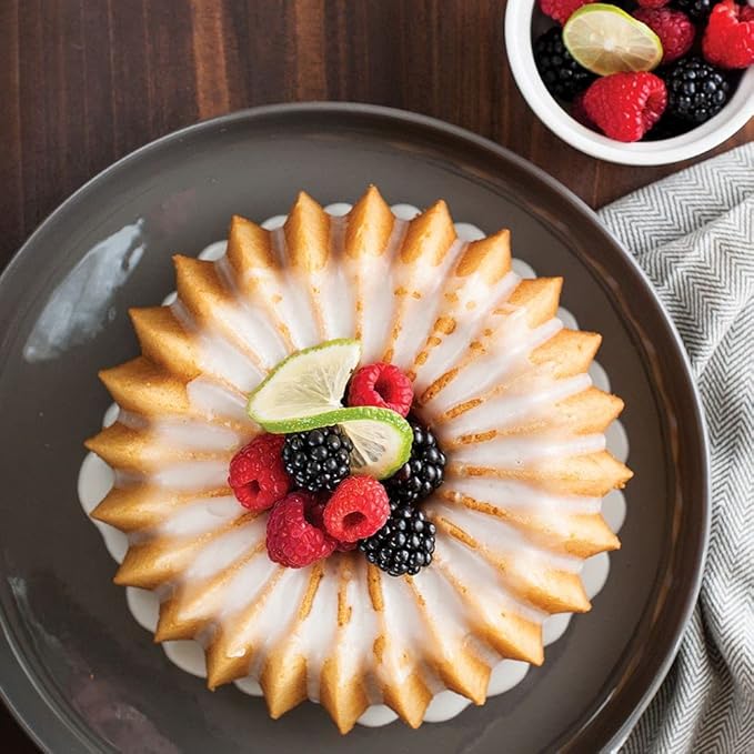 Nordic Ware | Brilliance 5 Cup Bundt pan showcasing a fruit-topped cake, highlighting its intricate design and even browning capabilities for perfect baking results.