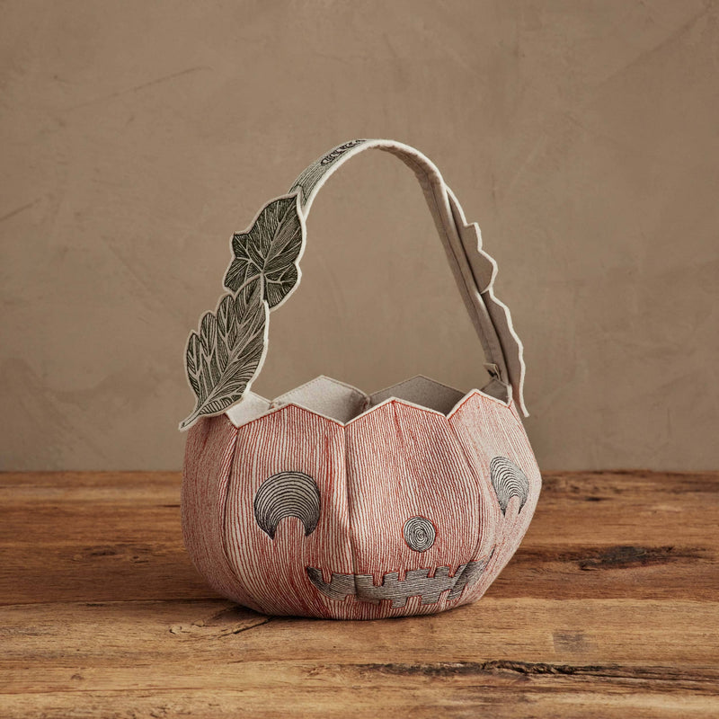 Coral & Tusk - Jack-o'-Lantern Basket, a soft-fabric pumpkin-shaped Halloween container with stitched details and a leaf-decorated handle, perfect for festive trick-or-treating.
