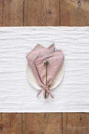 Set of 2 linen napkins elegantly arranged with a tied flower on a plate, showcasing premium linen quality for versatile table decor.