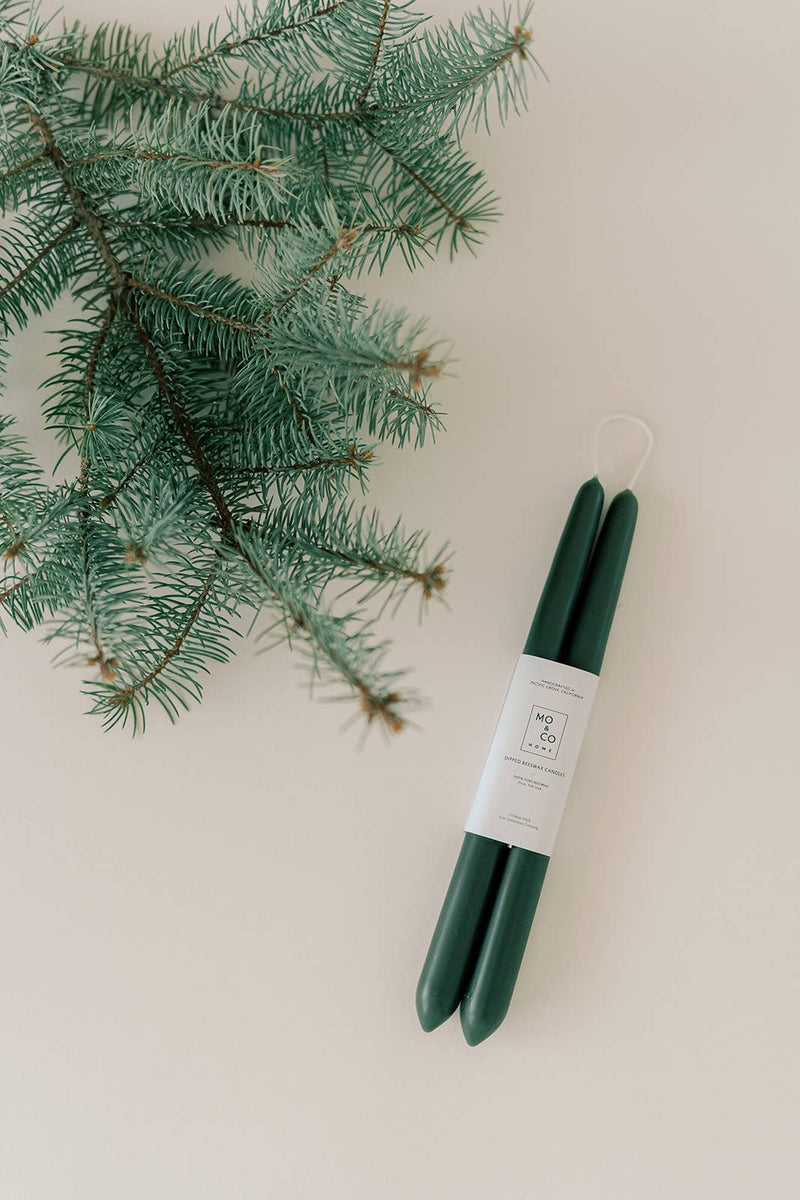 Mo&Co Home - Forest Green | Dipped Beeswax Taper Candles, handcrafted, dark-green, paired with a white label, on a light-beige surface, eco-conscious and air-purifying.