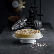 Pillivuyt Cake Stand showcasing a beautifully crafted cake, highlighting French porcelain elegance, perfect for any culinary display.