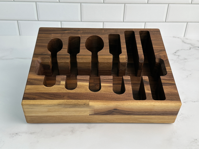 Loudblade - Custom Solid Walnut Wooden Flatware Drawer Organizer on countertop, displaying empty slots for flatware storage, showcasing its elegant, handcrafted design from Athens Cooks.