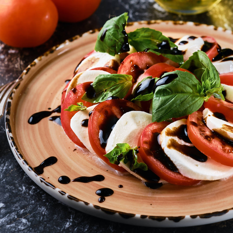 Giusti - 1 Silver Medal Balsamic Vinegar of Modena enhances a classic Caprese salad with its rich, rounded acidity and historical elegance.