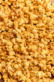 Poppy Handcrafted Popcorn - Pimento Cheese, featuring bright orange, cheese-coated popcorn with a southern pimento twist, reflecting Athens Cooks' specialty food offerings.