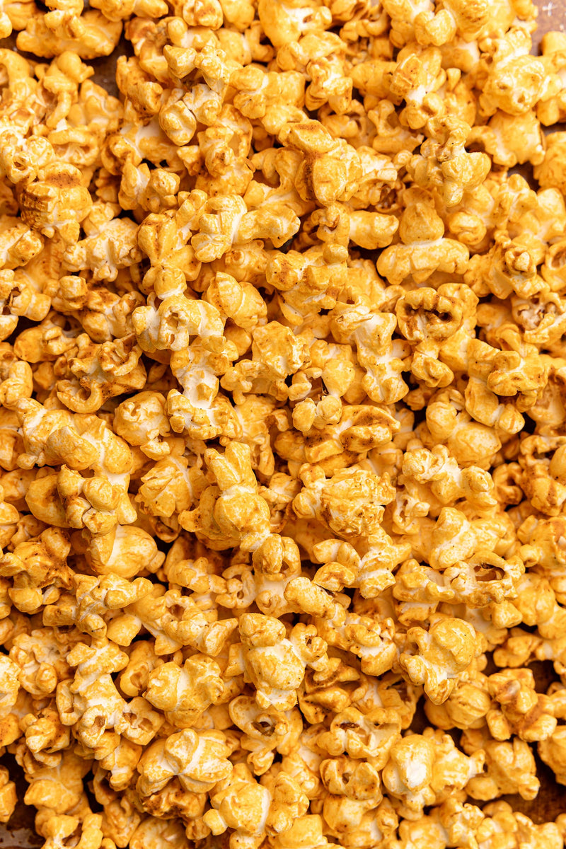 Poppy Handcrafted Popcorn - Pimento Cheese, featuring bright orange, cheese-coated popcorn with a southern pimento twist, reflecting Athens Cooks' specialty food offerings.