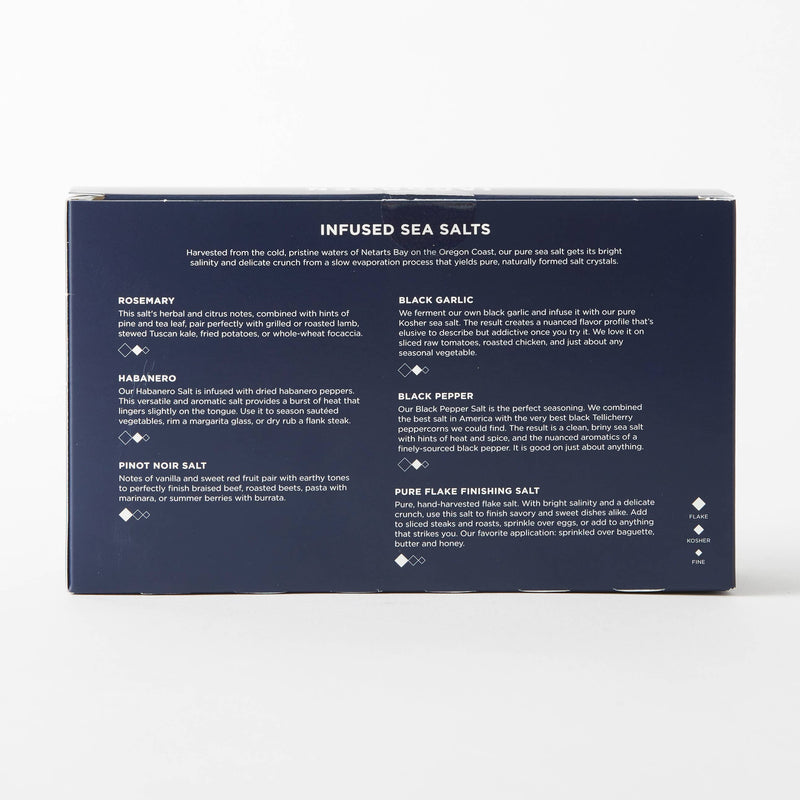 Jacobsen Salt Co. - Infused Sea Salt Gift Set featuring six flavored salts in vials with a wooden stand, perfect for diverse culinary pairings.