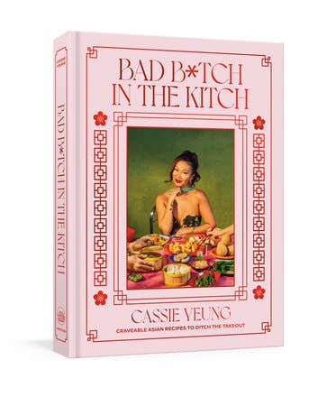 Cookbook cover of “BAD B*TCH IN THE KITCH” by Cassie Yeling, featuring Asian recipes and a photo of the author with a spread of dishes.
